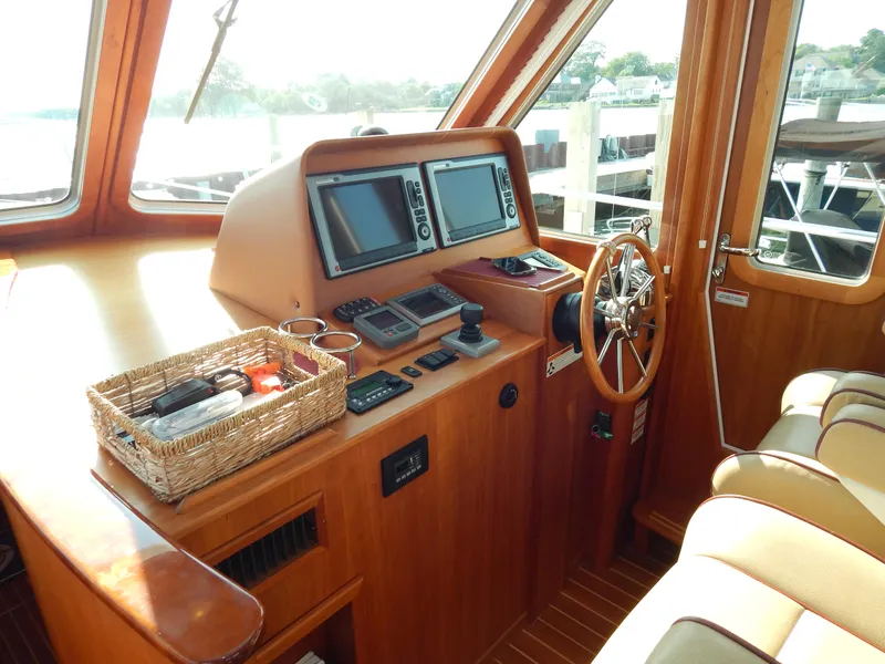 Slide: The Image of 2010 Sabre 40 Sedan helm with navigation equipment and wooden steering wheel. - 12