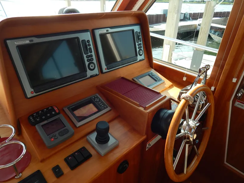 Slide: The Image of Helm of 2010 Sabre 40 Sedan with navigation screens and wooden steering wheel. - 14