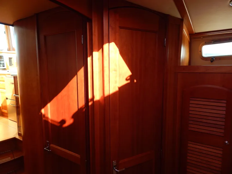 Slide: The Image of Interior of 2010 Sabre 40 Sedan with wooden cabinetry and sunlight streaming through a window. - 15