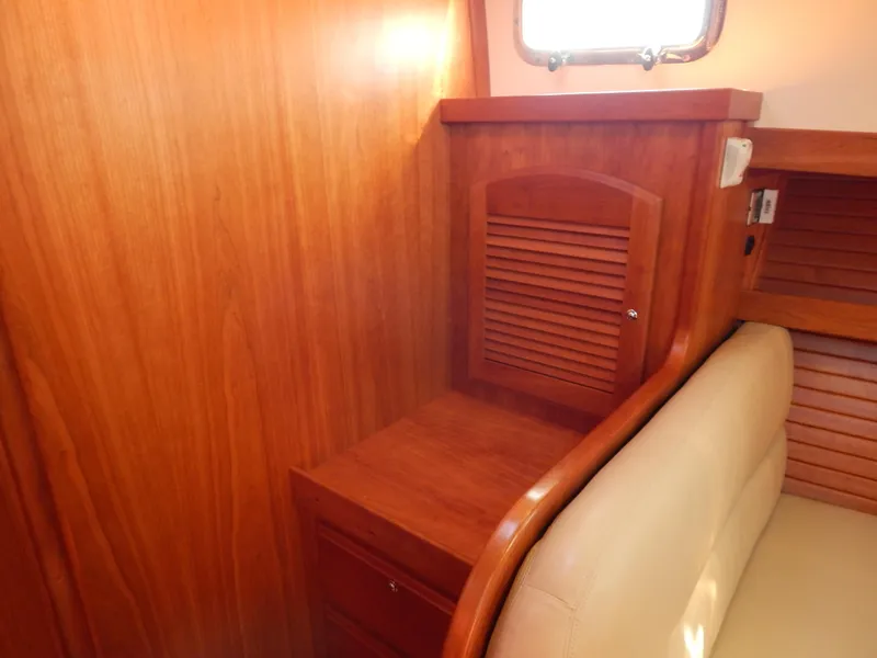 Slide: The Image of Interior of 2010 Sabre 40 Sedan with wooden cabinetry and beige seating. - 16