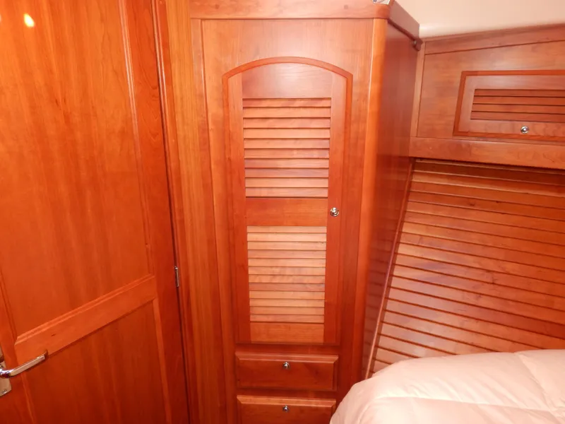 Slide: The Image of 2010 Sabre 40 Sedan interior with wooden cabinetry and louvered doors. - 17