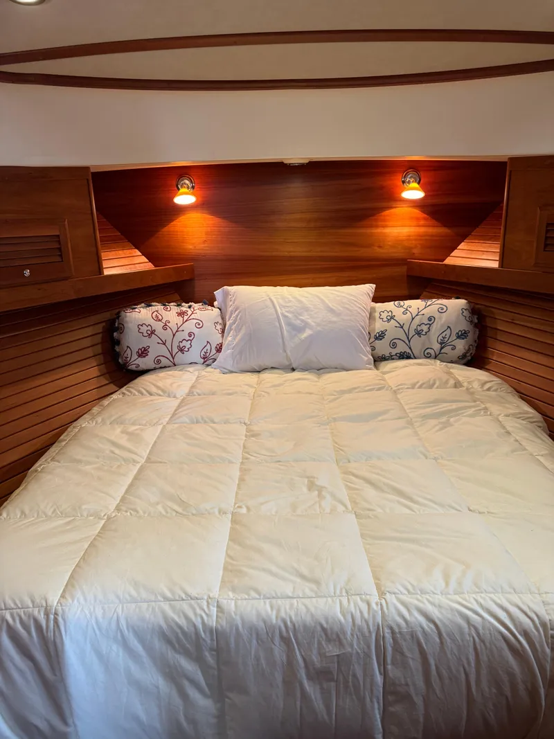 Slide: The Image of Cozy cabin bedroom in 2010 Sabre 40 Sedan yacht with wooden walls and soft lighting. - 19