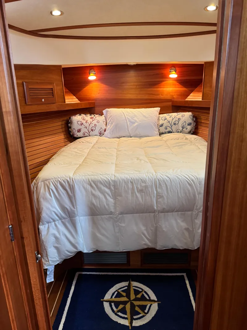 Slide: The Image of Cozy bedroom in 2010 Sabre 40 Sedan yacht with wood paneling and nautical decor. - 20