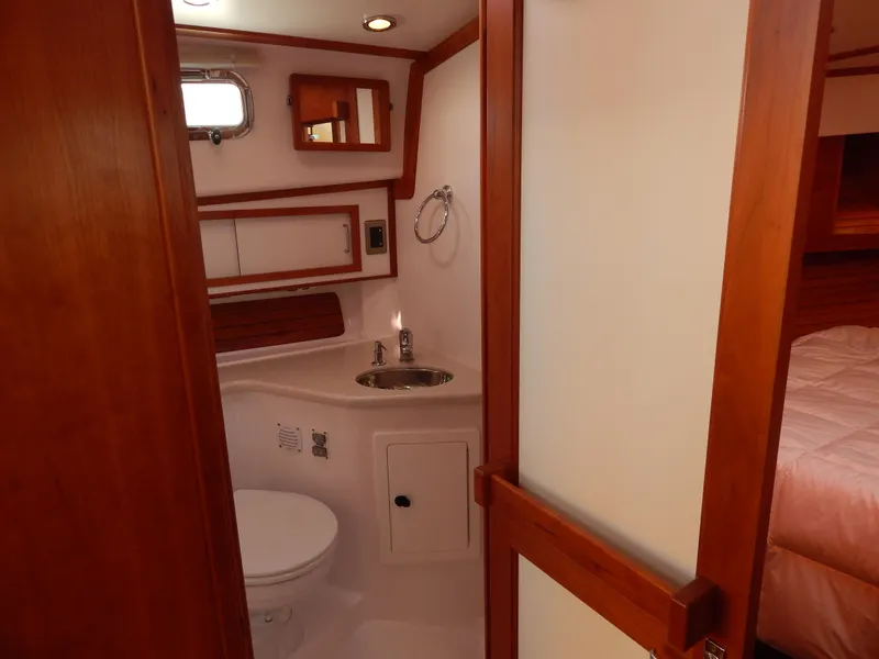 Slide: The Image of 2010 Sabre 40 Sedan yacht bathroom with wooden accents and compact design. - 22