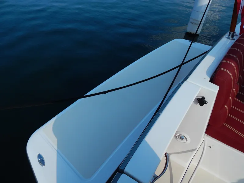 Slide: The Image of 2010 Sabre 40 Sedan boat deck with red seating and water view. - 26