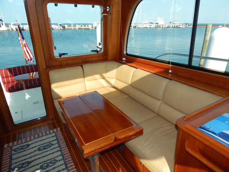 Slide: The Image of Luxurious interior of 2010 Sabre 40 Sedan yacht with beige seating and wooden table. - 27