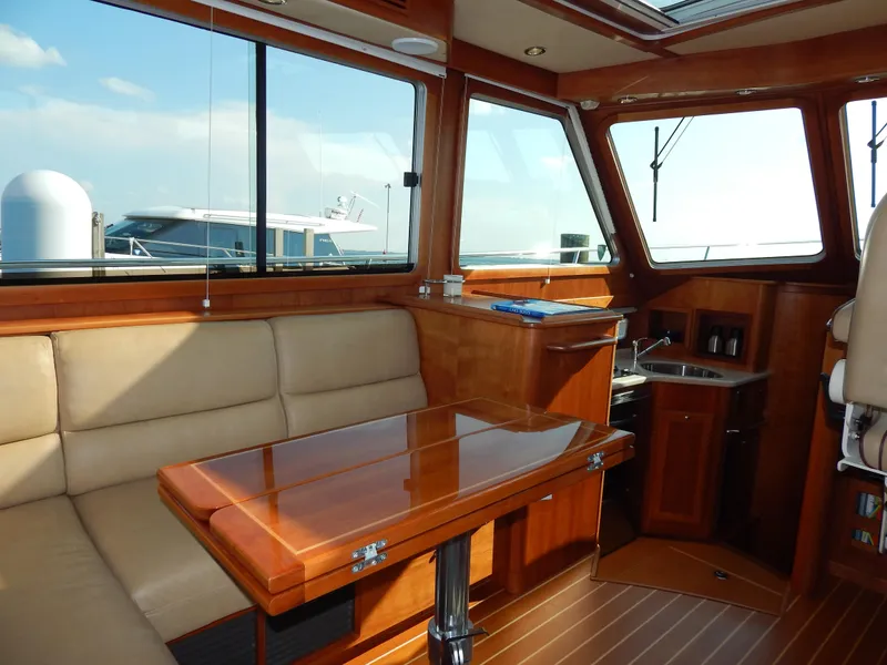 Slide: The Image of Interior of 2010 Sabre 40 Sedan yacht with wooden furnishings and seating area. - 28