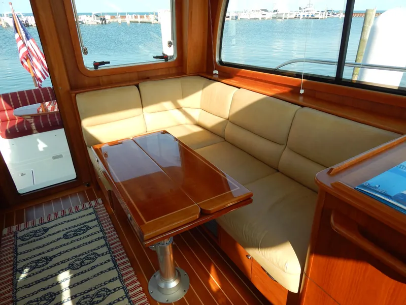Slide: The Image of Luxurious interior of 2010 Sabre 40 Sedan yacht with beige seating and wooden table. - 29