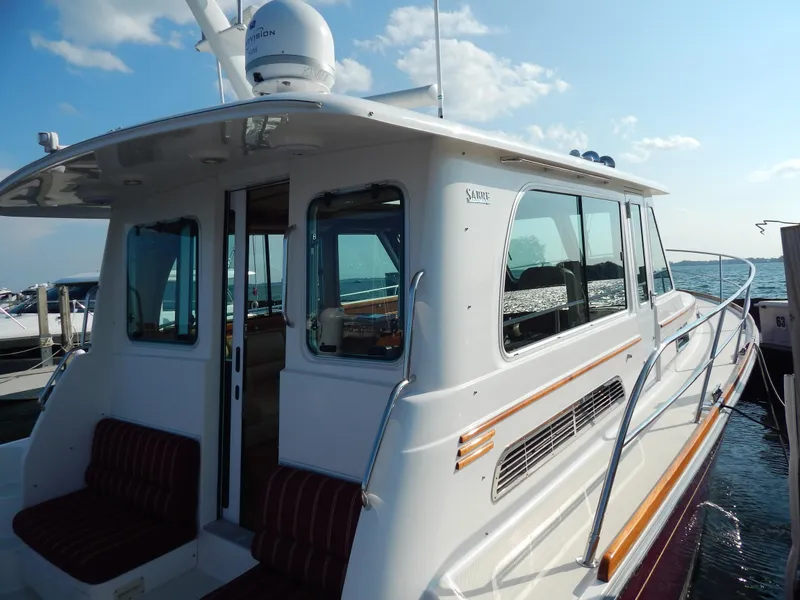 Slide: The Image of 2010 Sabre 40 Sedan yacht docked, featuring sleek design and spacious interior. - 3