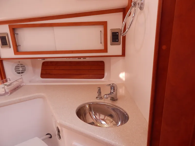 Slide: The Image of 2010 Sabre 40 Sedan yacht bathroom with sink, wooden accents, and modern fixtures. - 31