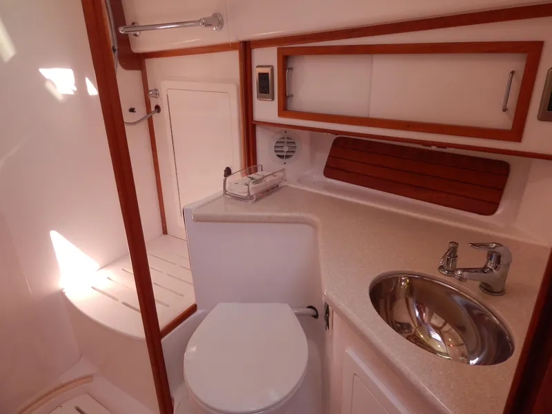 Slide: The Image of 2010 Sabre 40 Sedan yacht bathroom with sink, toilet, and wooden accents. - 32