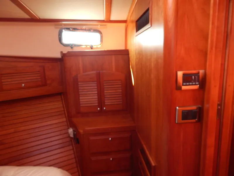 Slide: The Image of Interior of 2010 Sabre 40 Sedan yacht with wooden cabinetry and modern controls. - 37