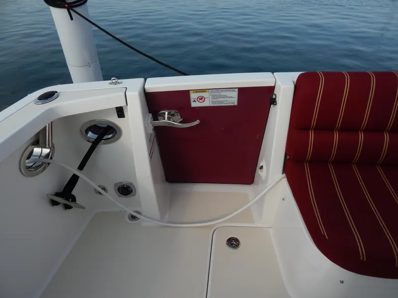 Slide: The Image of 2010 Sabre 40 Sedan boat deck with maroon seating and water hose. - 44