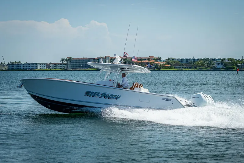 The Image of 2023 Jupiter 38 boat cruising on water with buildings in the background. - 0