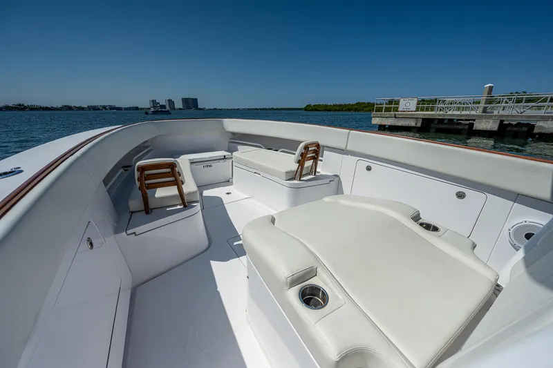 Slide: The Image of 2023 Jupiter 38 boat interior with white seating, cup holders, and ocean view. - 11