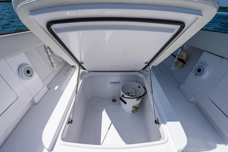 Slide: The Image of Open storage compartment on 2023 Jupiter 38 boat with bucket inside. - 14