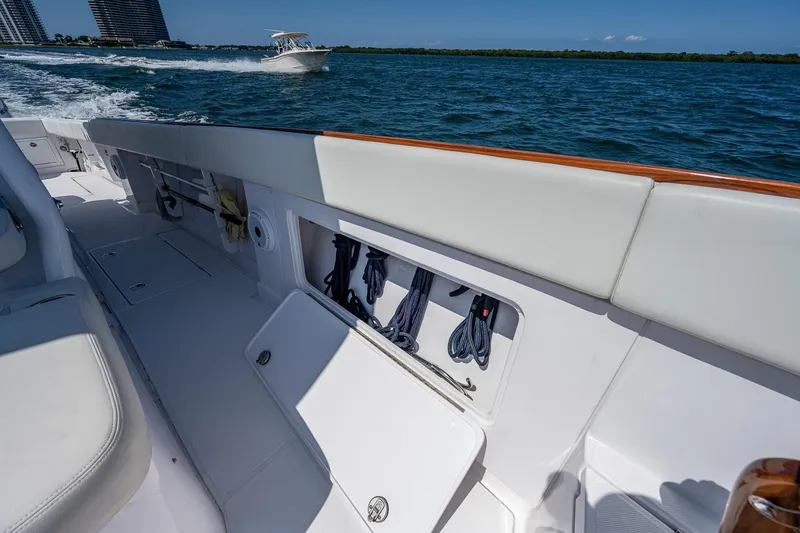 Slide: The Image of 2023 Jupiter 38 boat interior with storage compartment, cruising on open water. - 17