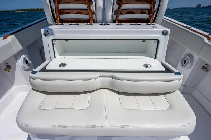 Slide: The Image of 2023 Jupiter 38 boat with open storage compartment and cushioned seating. - 20