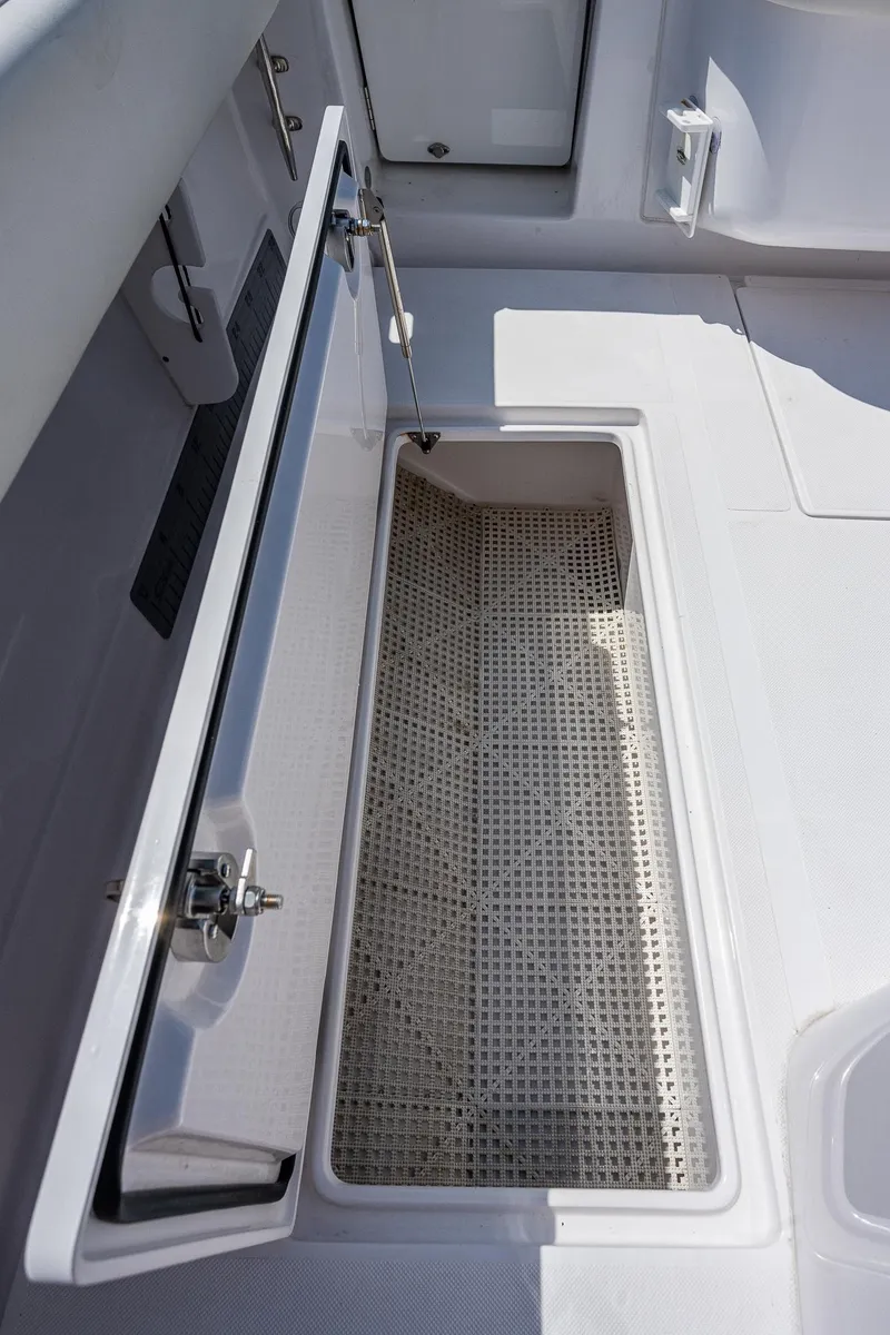 Slide: The Image of Open storage compartment on a 2023 Jupiter 38 boat deck. - 23