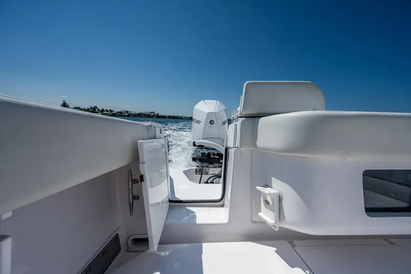 Slide: The Image of 2023 Jupiter 38 boat interior with open door, outboard motor, and clear blue sky. - 24