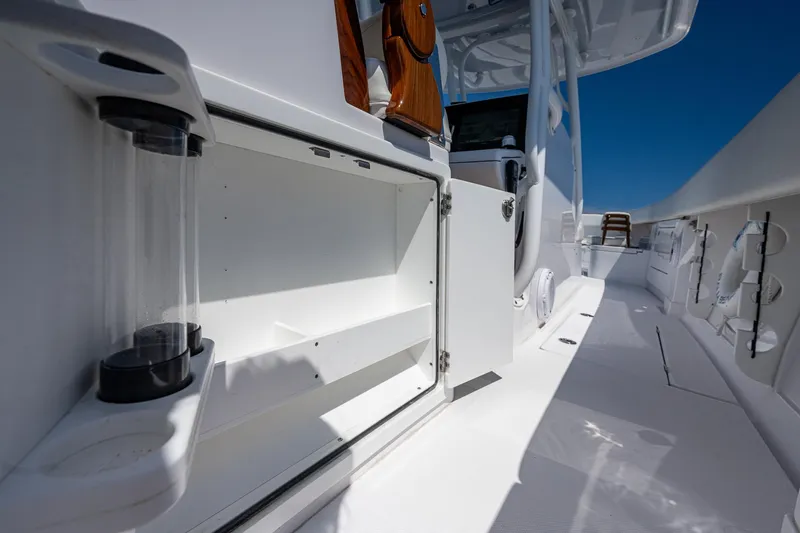 Slide: The Image of 2023 Jupiter 38 boat interior with open storage compartment and rod holders. - 28