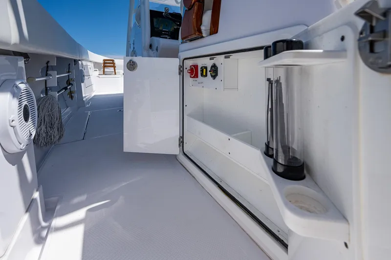 Slide: The Image of 2023 Jupiter 38 boat interior with open storage compartment and equipment. - 29