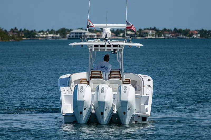 Slide: The Image of 2023 Jupiter 38 boat with triple outboard engines cruising on a calm sea. - 3