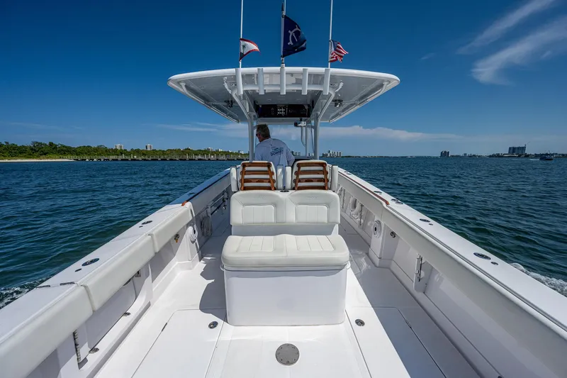 Slide: The Image of 2023 Jupiter 38 boat cruising on open water under clear blue sky. - 30