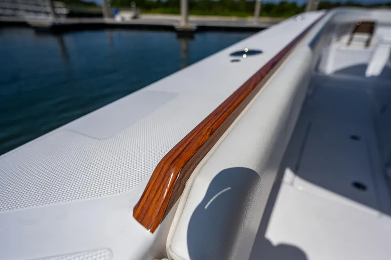 Slide: The Image of 2023 Jupiter 38 boat with sleek wooden railing detail. - 34