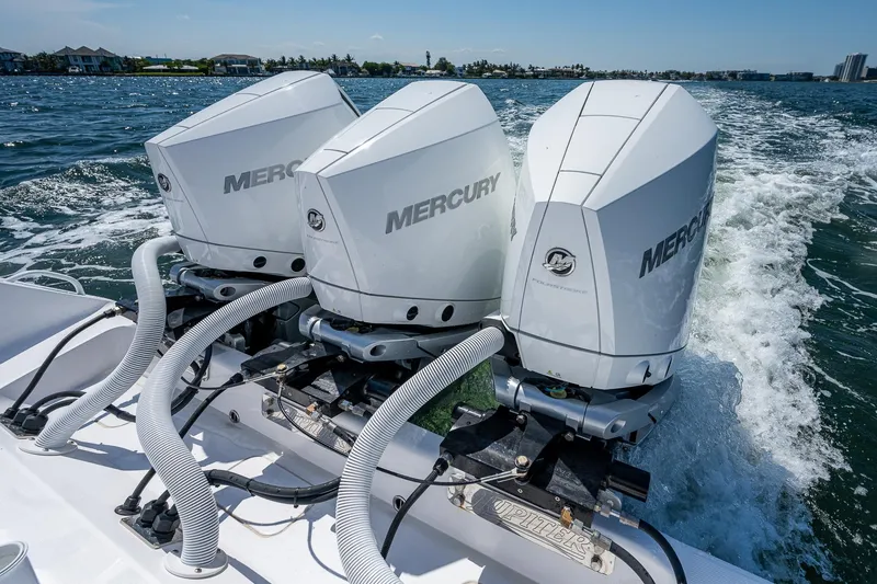 Slide: The Image of Triple Mercury outboard engines on a 2023 Jupiter 38 boat cruising on water. - 35