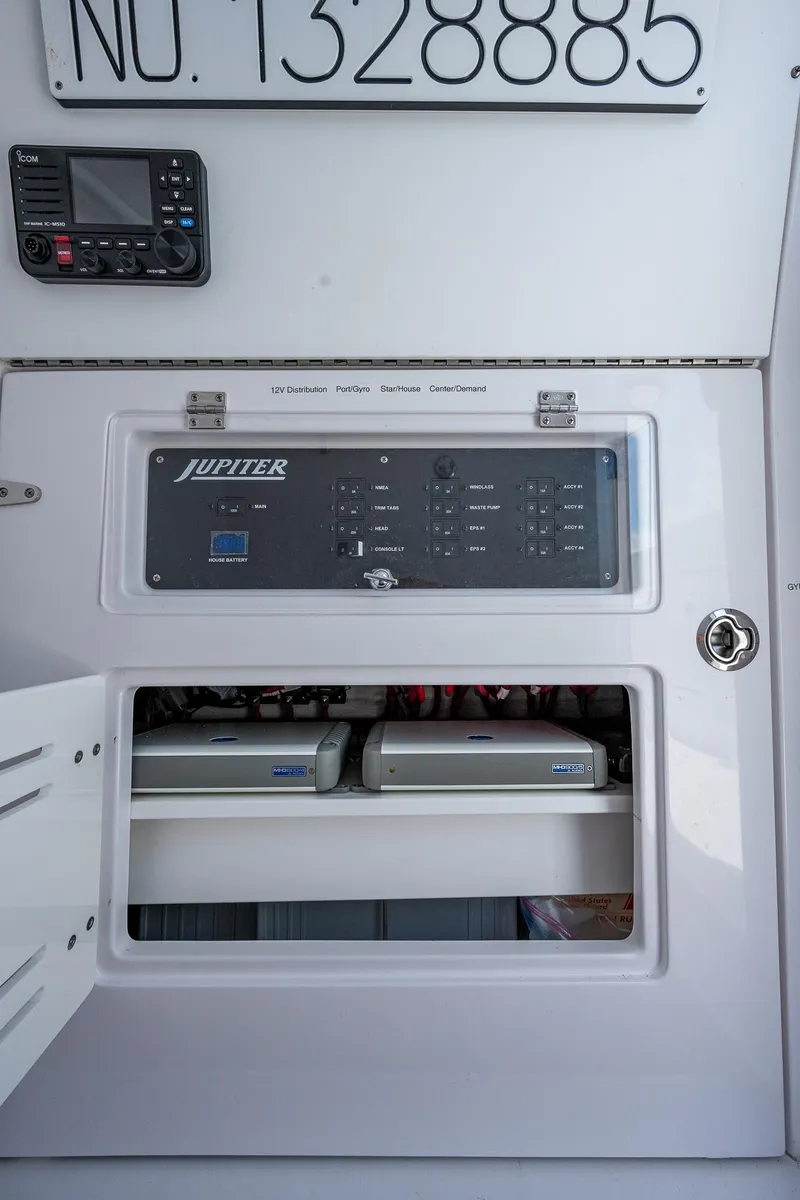 Slide: The Image of Control panel and equipment storage on a 2023 Jupiter 38 boat. - 38