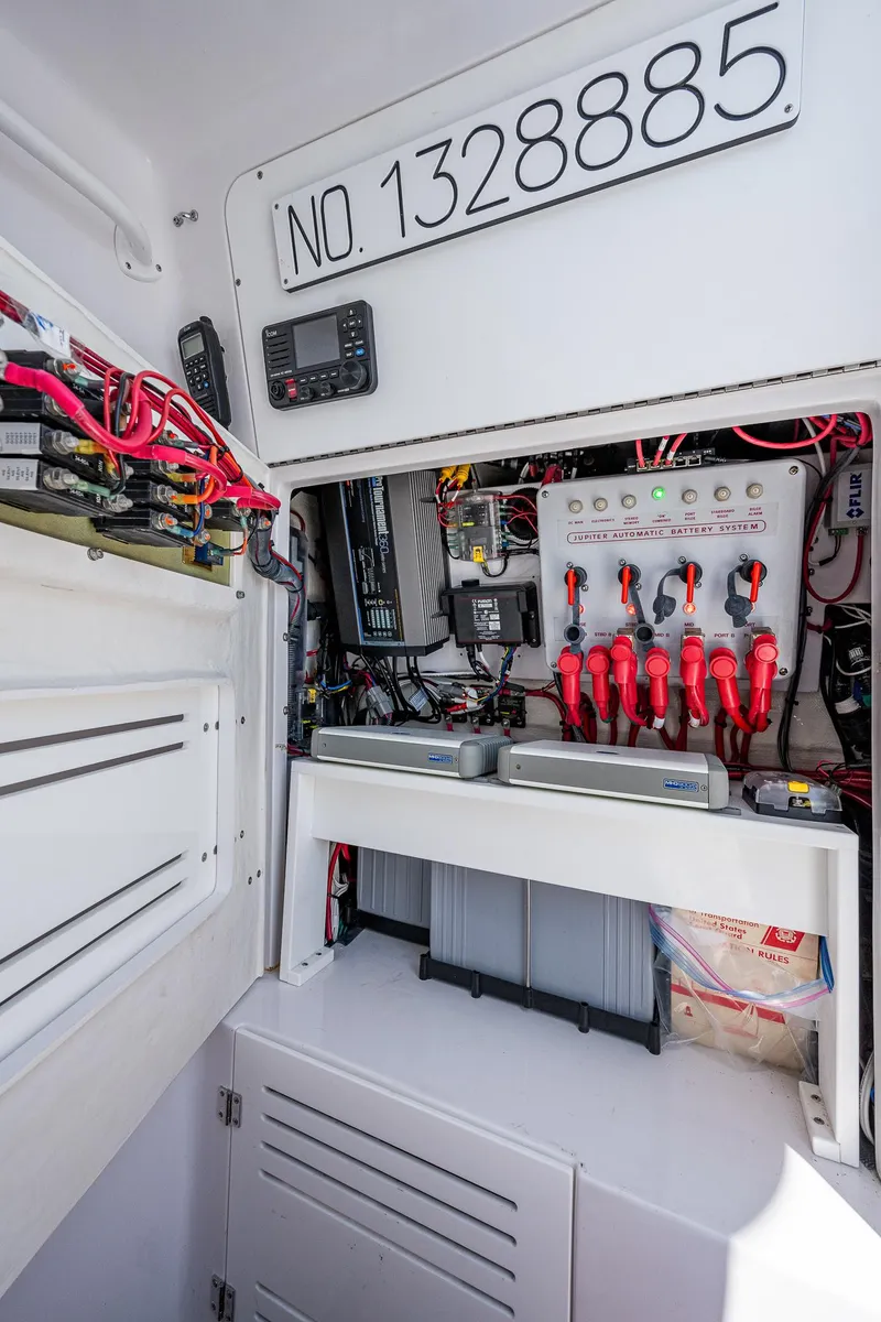 Slide: The Image of Electrical panel inside 2023 Jupiter 38 boat, showcasing wiring and control systems. - 39