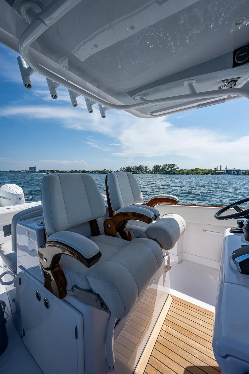 Slide: The Image of Luxury seating on a 2023 Jupiter 38 boat, overlooking serene waters and clear skies. - 45