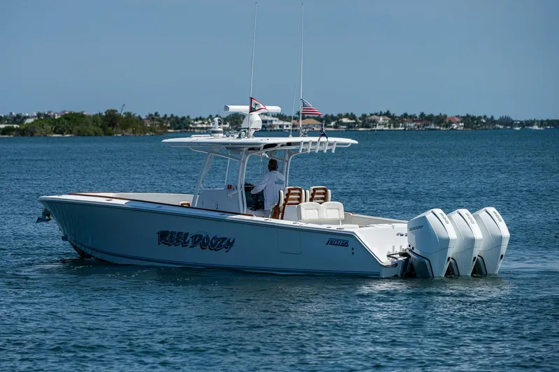 Slide: The Image of 2023 Jupiter 38 boat with triple engines cruising on a sunny day. - 49