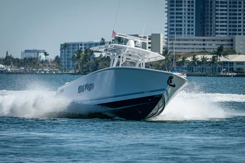 Slide: The Image of 2023 Jupiter 38 boat cruising on water near city skyline. - 5