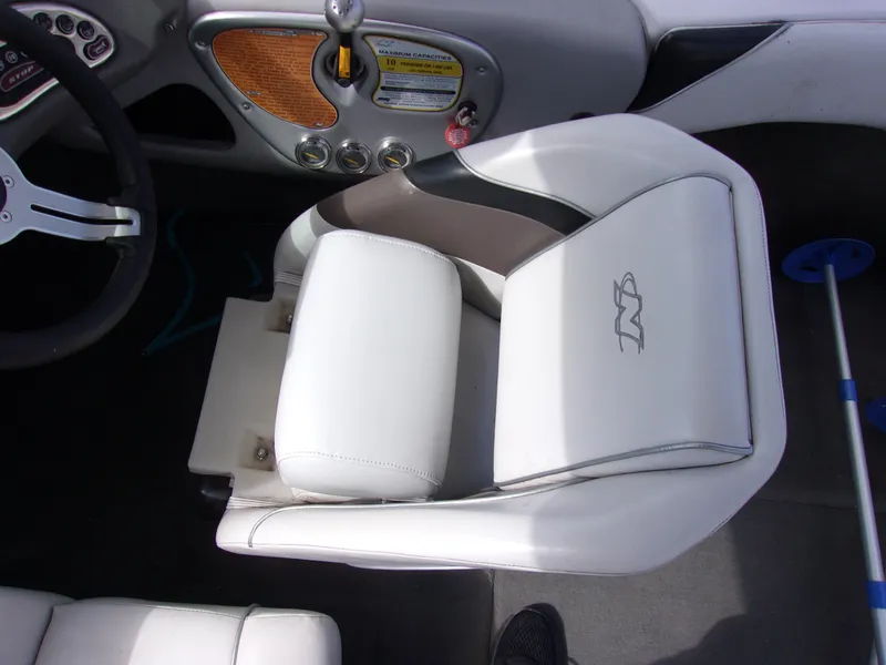 Slide: The Image of 2006 Correct Craft SUPER AIR NAUTIQUE 210 boat interior with white captain's seat and steering wheel. - 12
