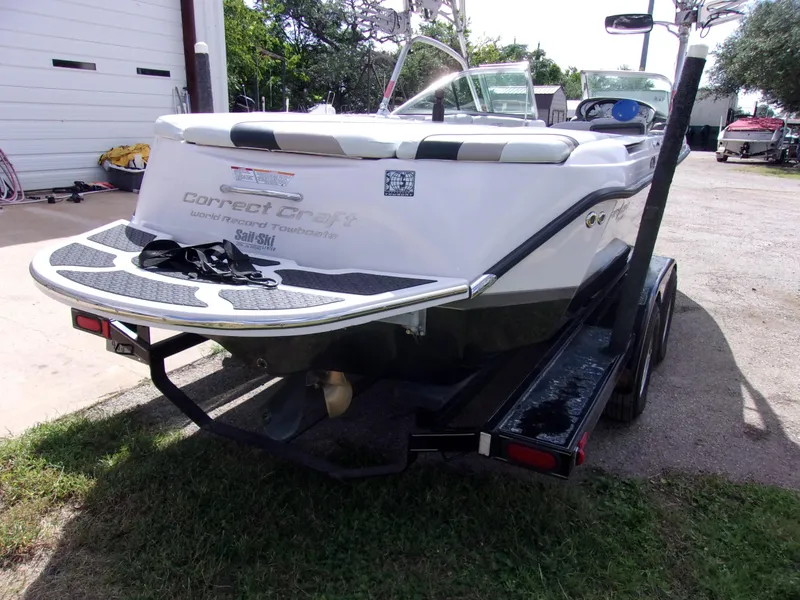 Slide: The Image of 2006 Correct Craft SUPER AIR NAUTIQUE 210 TEAM EDITION boat on trailer, rear view. - 3