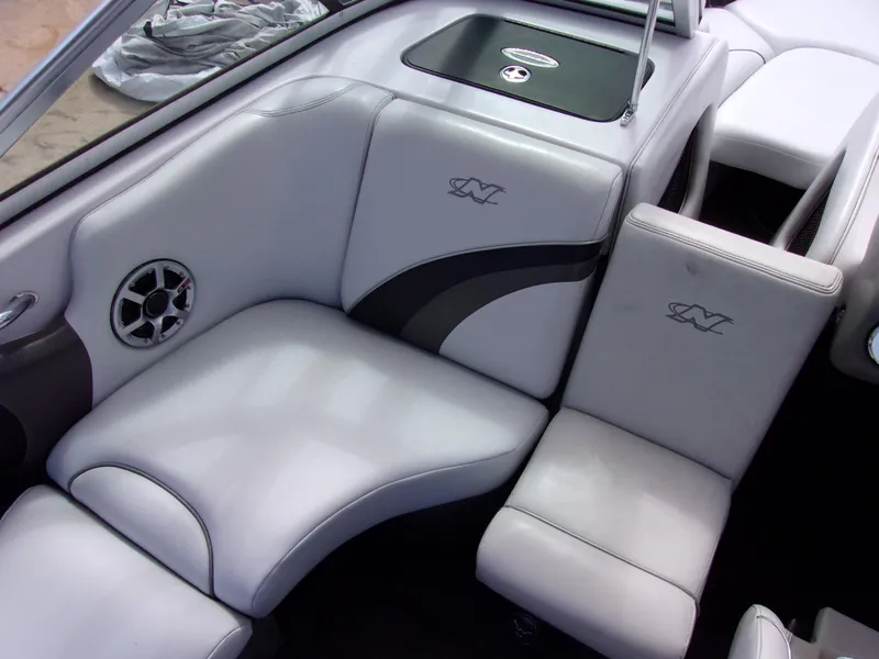 Slide: The Image of 2006 Correct Craft SUPER AIR NAUTIQUE 210 interior with gray seating and speaker detail. - 6