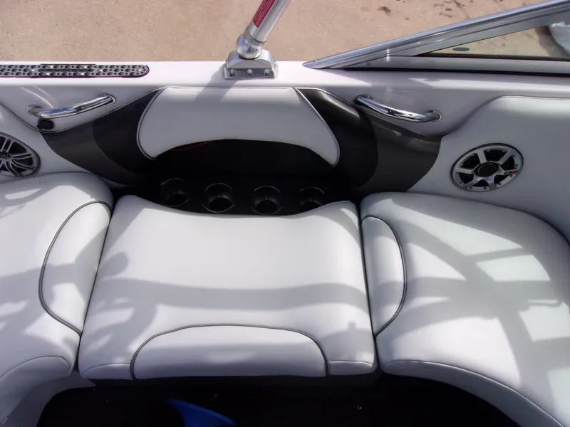 Slide: The Image of 2006 Correct Craft SUPER AIR NAUTIQUE 210 TEAM EDITION boat interior with white seating and cup holders. - 7