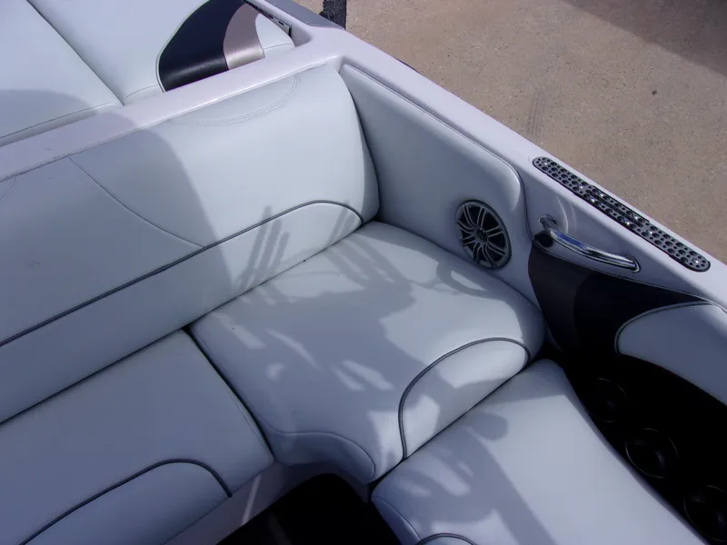 Slide: The Image of 2006 Correct Craft SUPER AIR NAUTIQUE 210 interior seating with speaker and handle detail. - 8