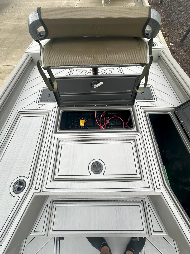 Slide: The Image of 2024 Thor 1900 Center Console boat interior with open storage compartments and wiring. - 10