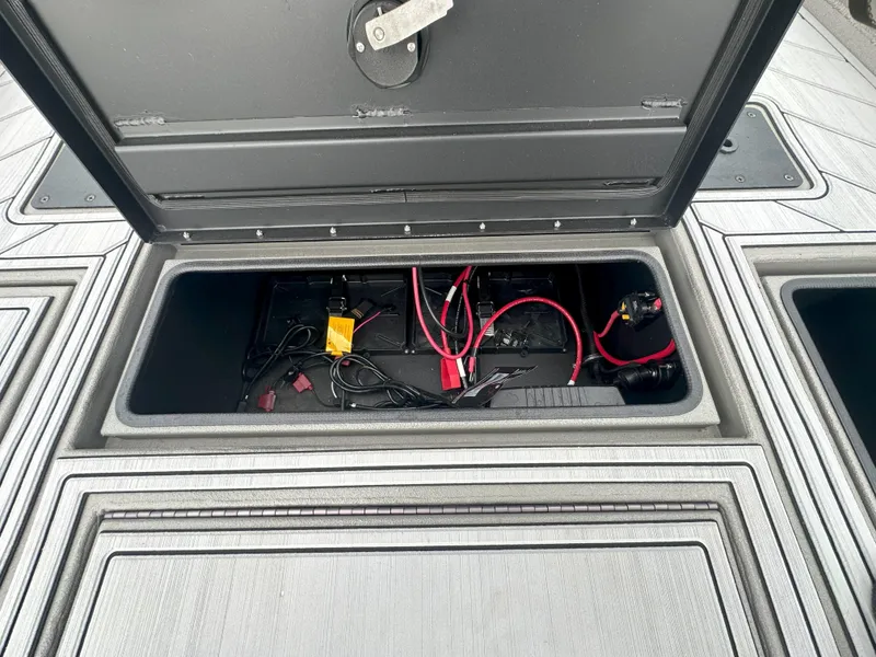 Slide: The Image of Open storage compartment in 2024 Thor 1900 Center Console boat, showing wiring and components. - 11