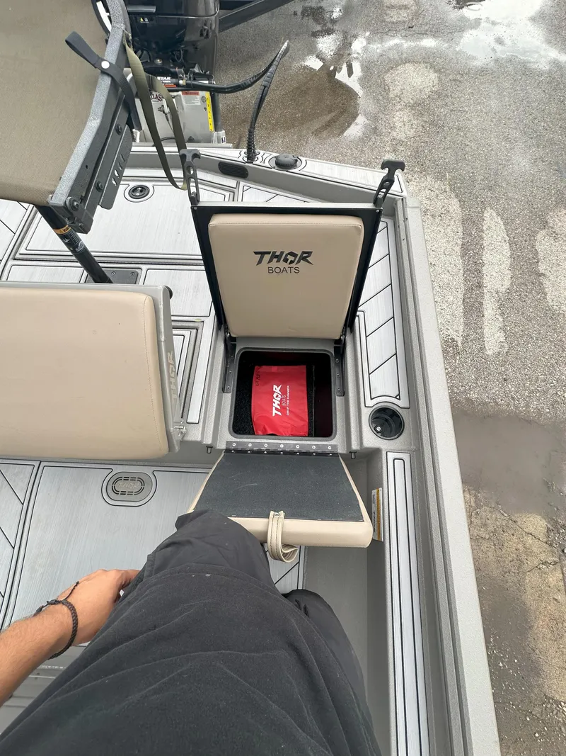 Slide: The Image of 2024 Thor 1900 Center Console boat interior with storage compartment open. - 18
