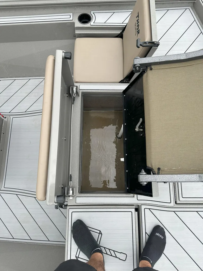 Slide: The Image of 2024 Thor 1900 Center Console boat interior with open storage compartment and seating. - 19