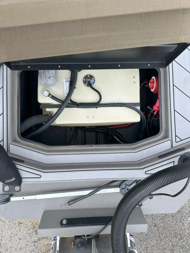 Slide: The Image of 2024 Thor 1900 Center Console boat's open storage compartment with visible wiring and components. - 20
