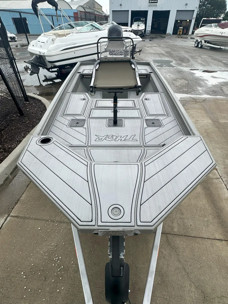 Slide: The Image of 2024 Thor 1900 Center Console boat on trailer, parked in marina lot. - 5