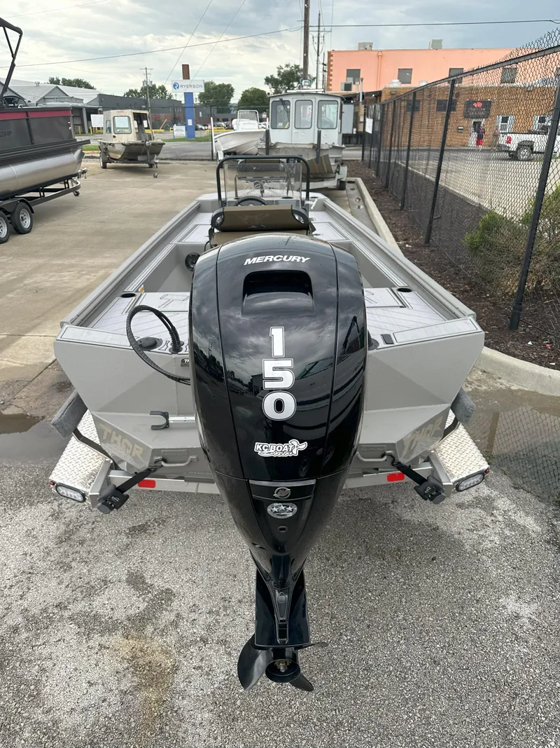 Slide: The Image of 2024 Thor 1900 Center Console boat with Mercury 150 outboard motor in a parking lot. - 7
