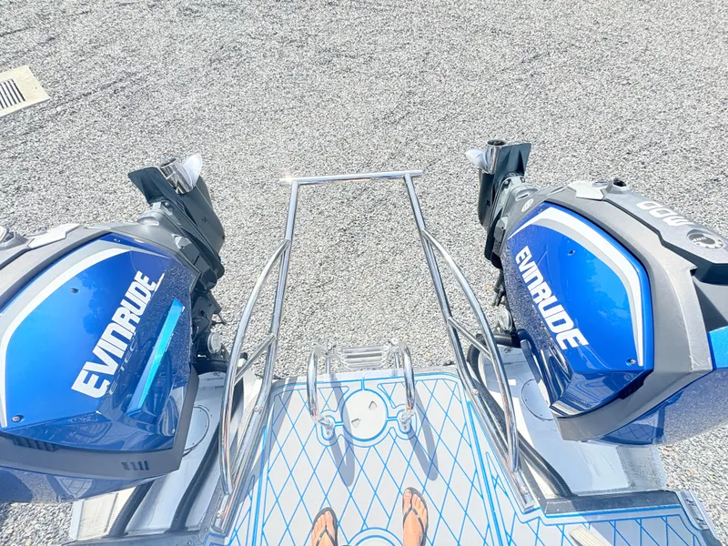 Slide: The Image of 2017 Manitou X-Plode Series 25 XT SRS SHP with dual Evinrude engines on a boat deck. - 10