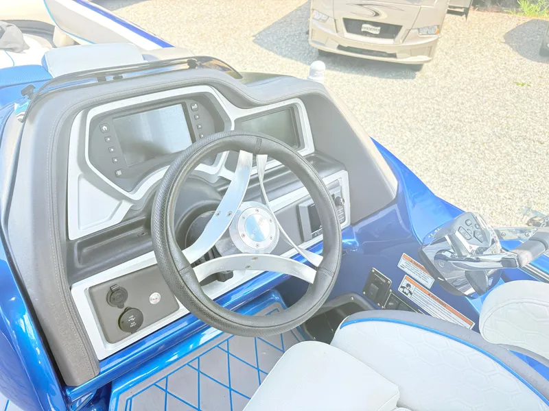 Slide: The Image of 2017 Manitou X-Plode Series 25 XT SRS SHP boat dashboard with steering wheel and controls. - 12