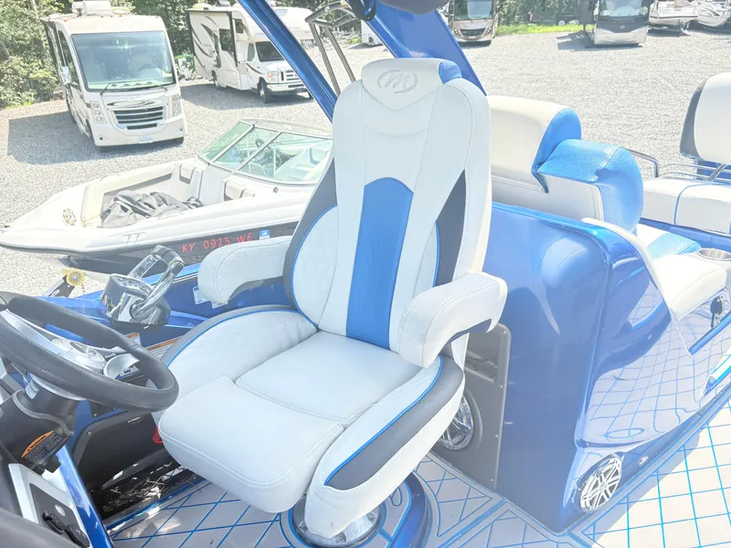 Slide: The Image of 2017 Manitou X-Plode Series 25 XT SRS SHP boat interior with luxurious captain's chair. - 13